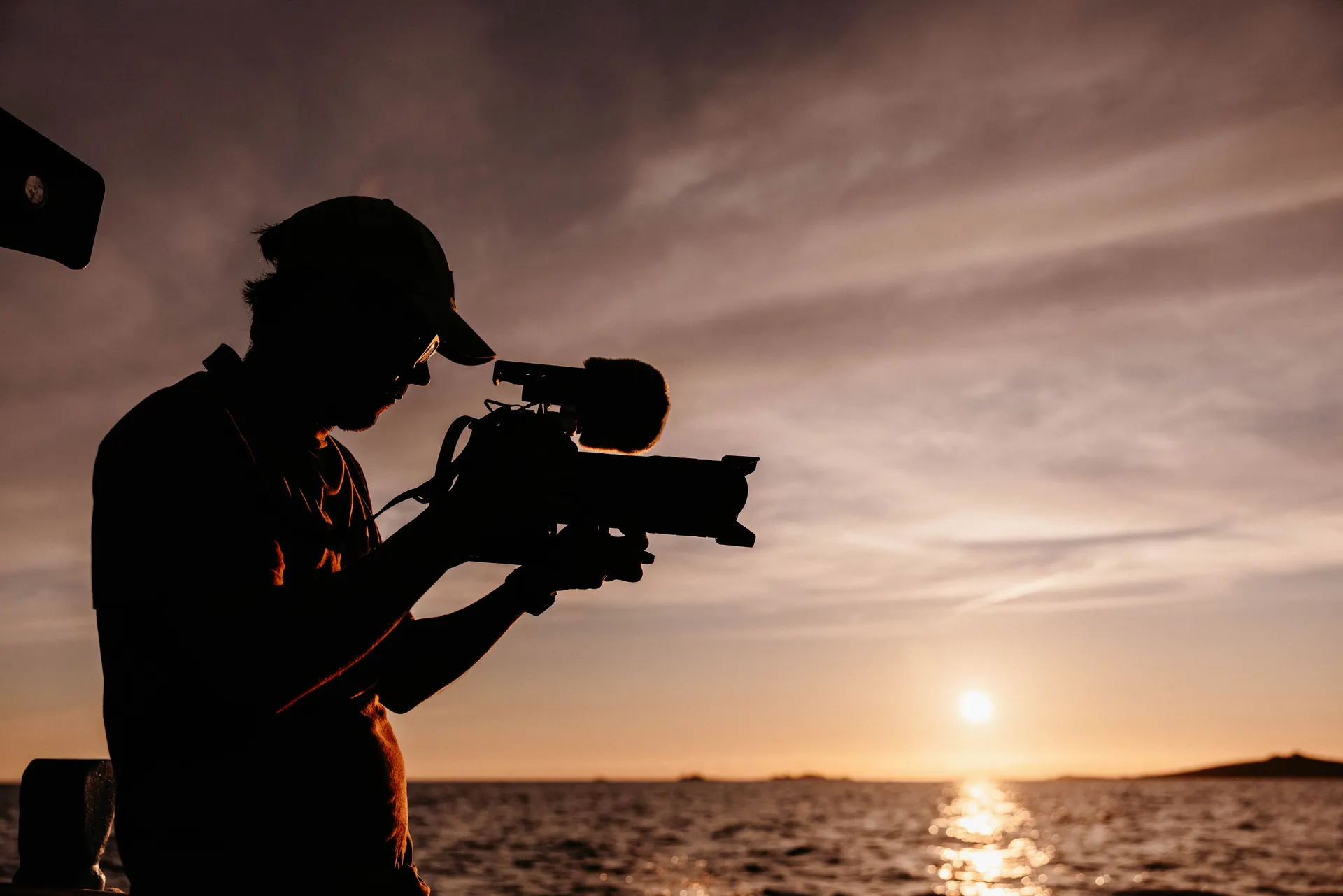 A PixelRain camera operator filming an Isles of Scilly Travel destination film at sunset